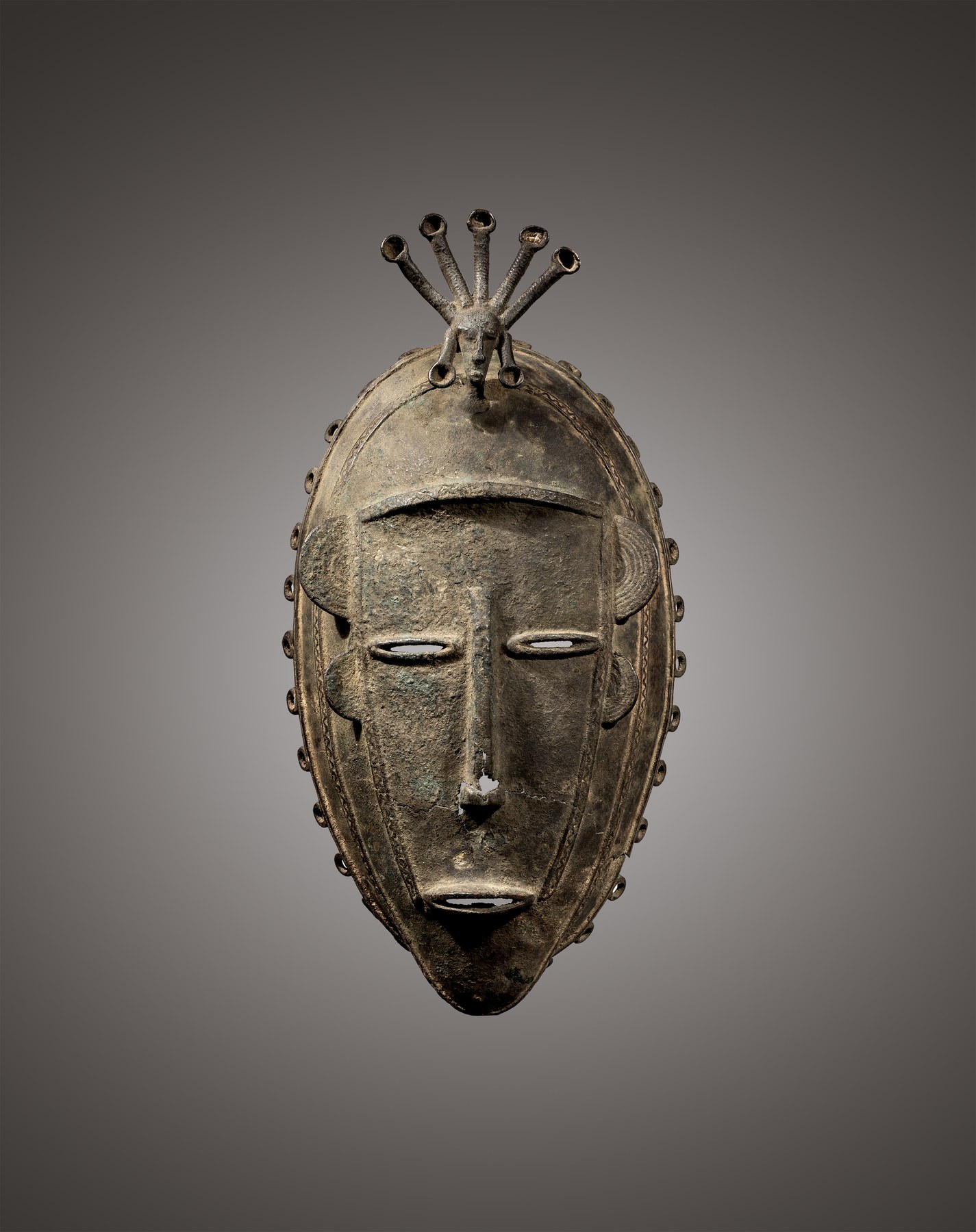 Diula face mask, Mankono area, Ivory Coast, 19th century, non-ferrous metal alloy, frontal view